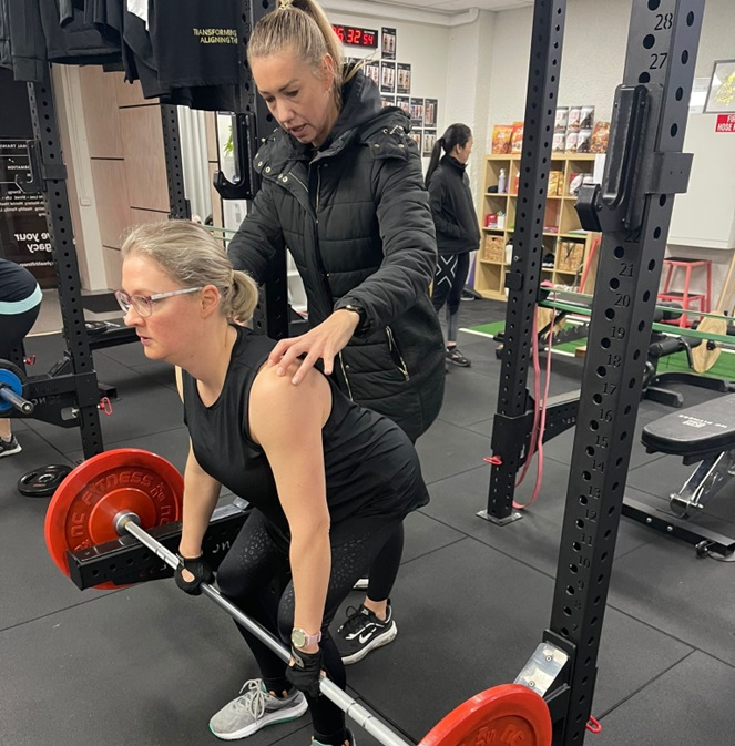 Corinne pic 1 Helping a gym member lift
